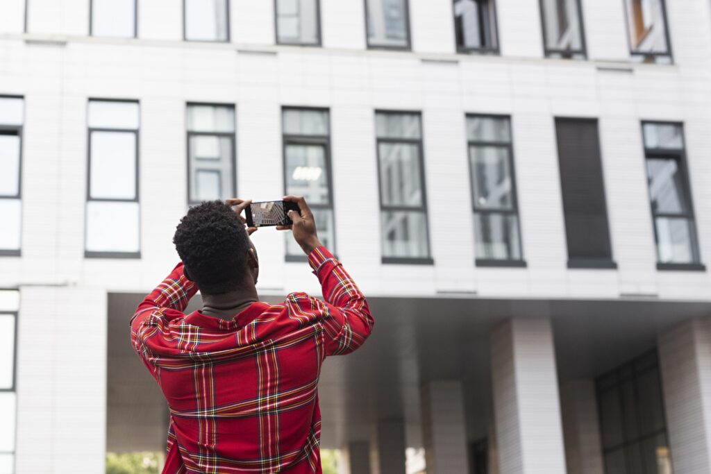 Address Verification 1 young male adult taking pictures building